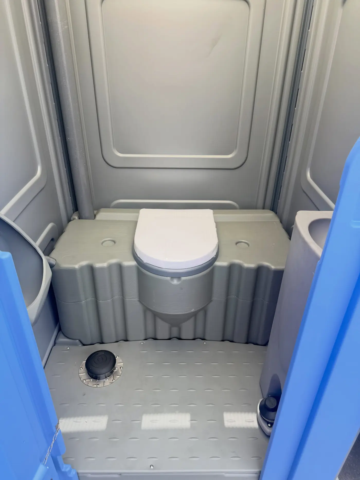 Interior of a gray porta potty prepared for winter